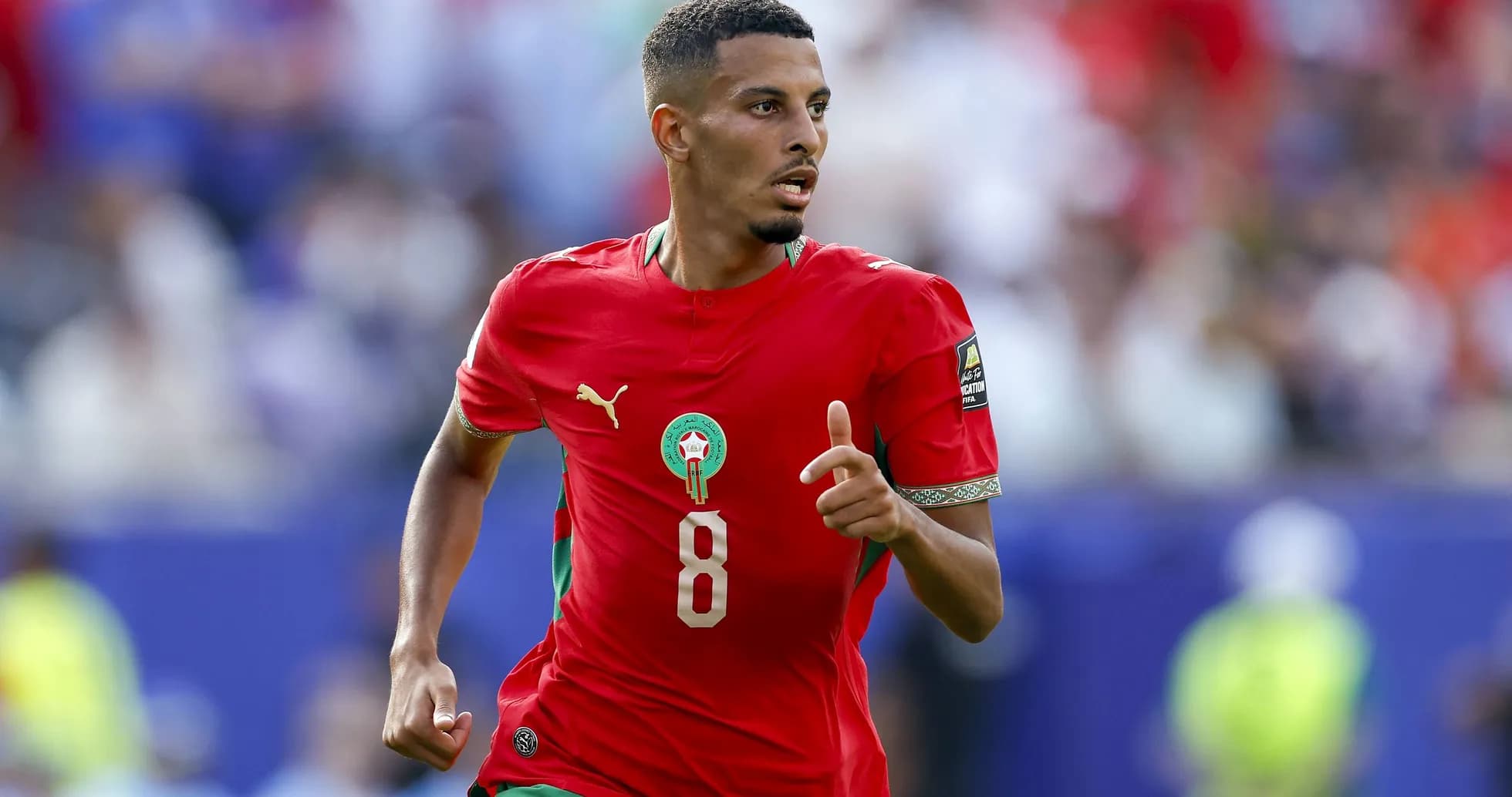 Player in red Morocco jersey running on field