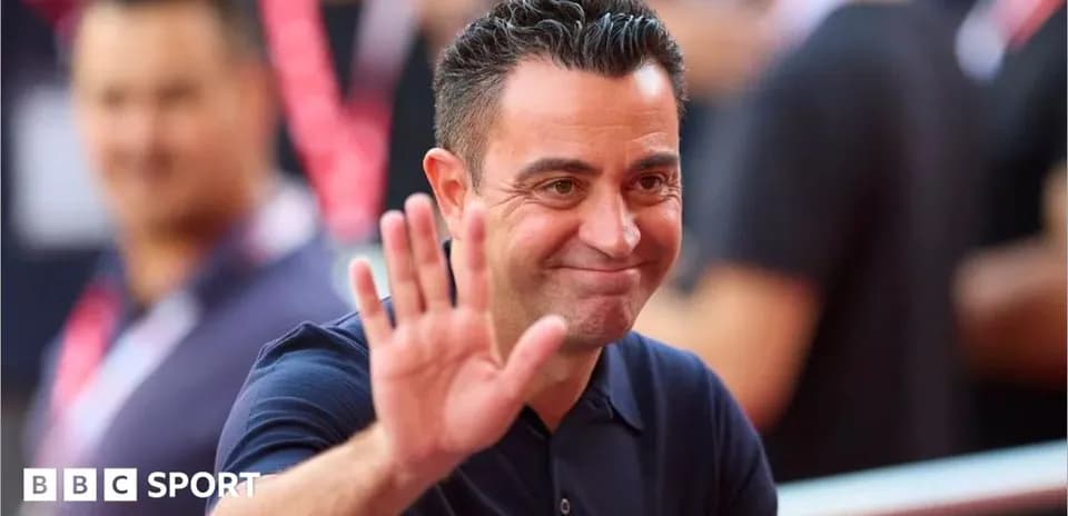 Coach waving to fans in a stadium setting