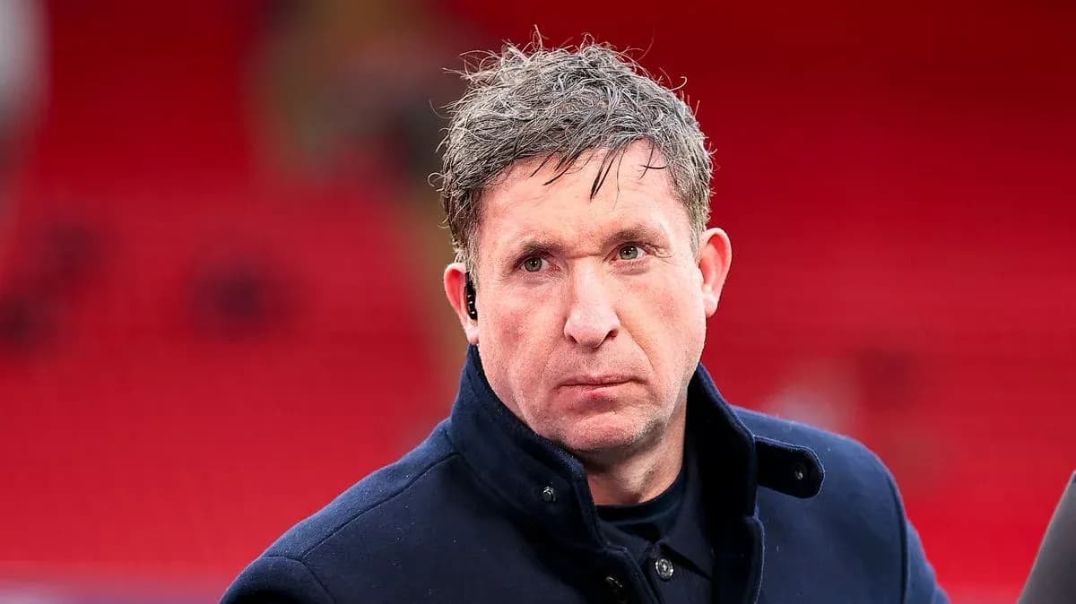 Man in a dark coat at a stadium