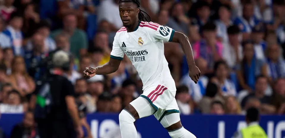 Player in white jersey running during football match