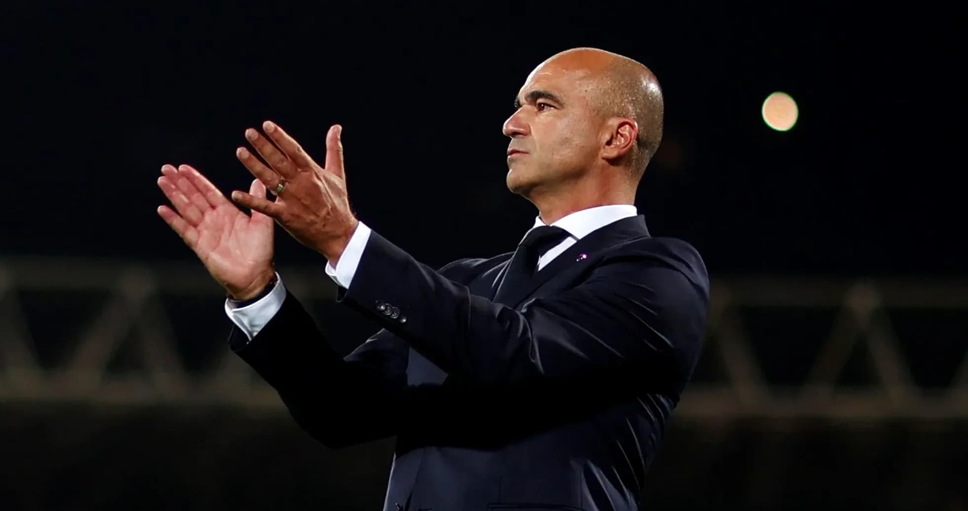 Coach applauding during a match on the sidelines