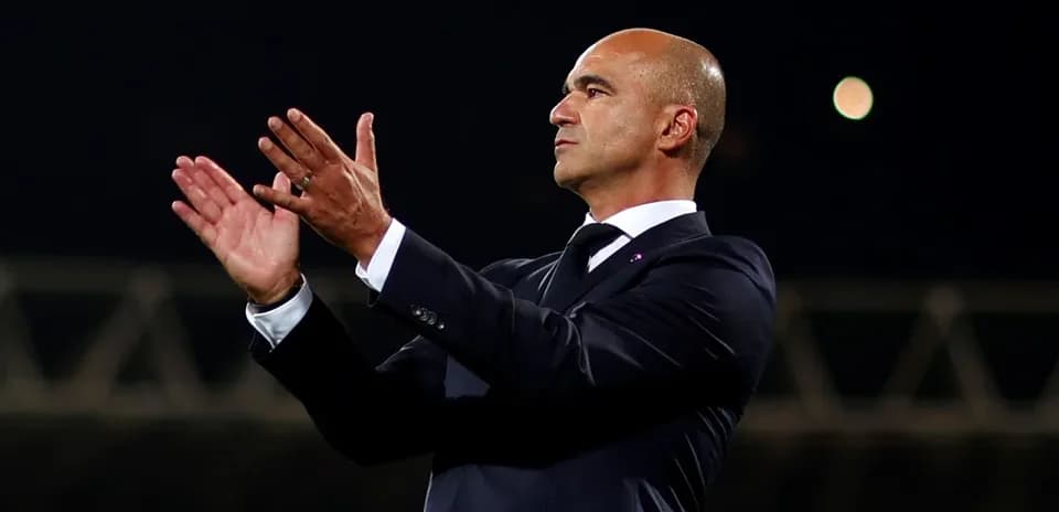 Coach applauding during a match on the sidelines