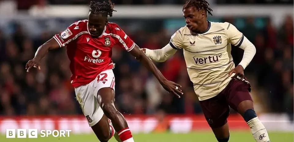 Two players competing for the ball during match