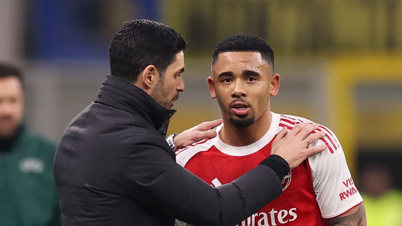 Coach speaking to player during match substitution