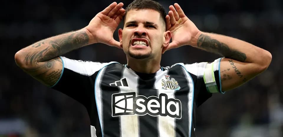 Player celebrating with hands to ears after goal