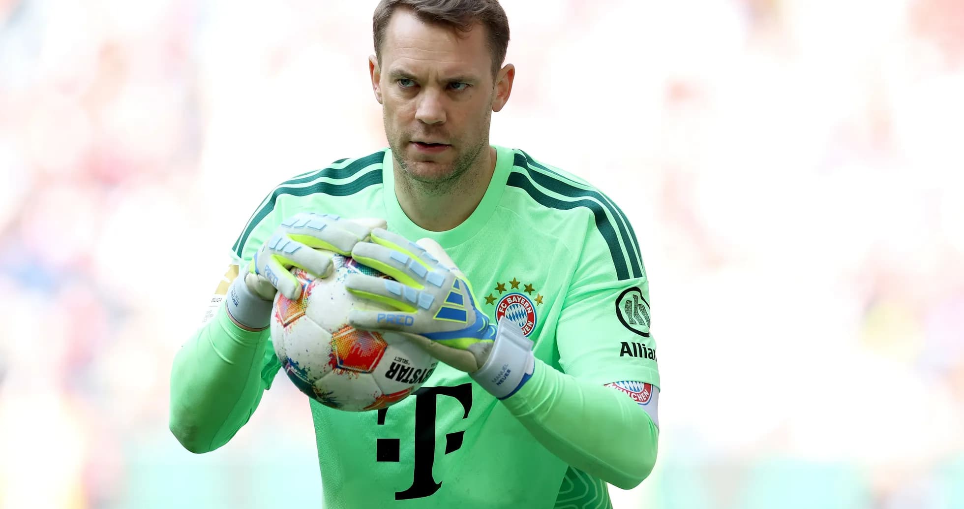 Goalkeeper holding ball during match warm-up