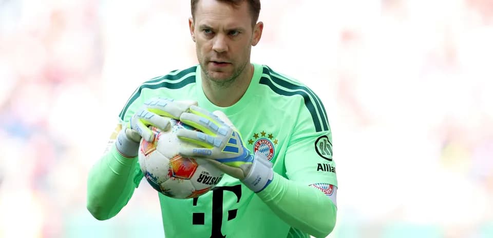 Goalkeeper holding ball during match warm-up