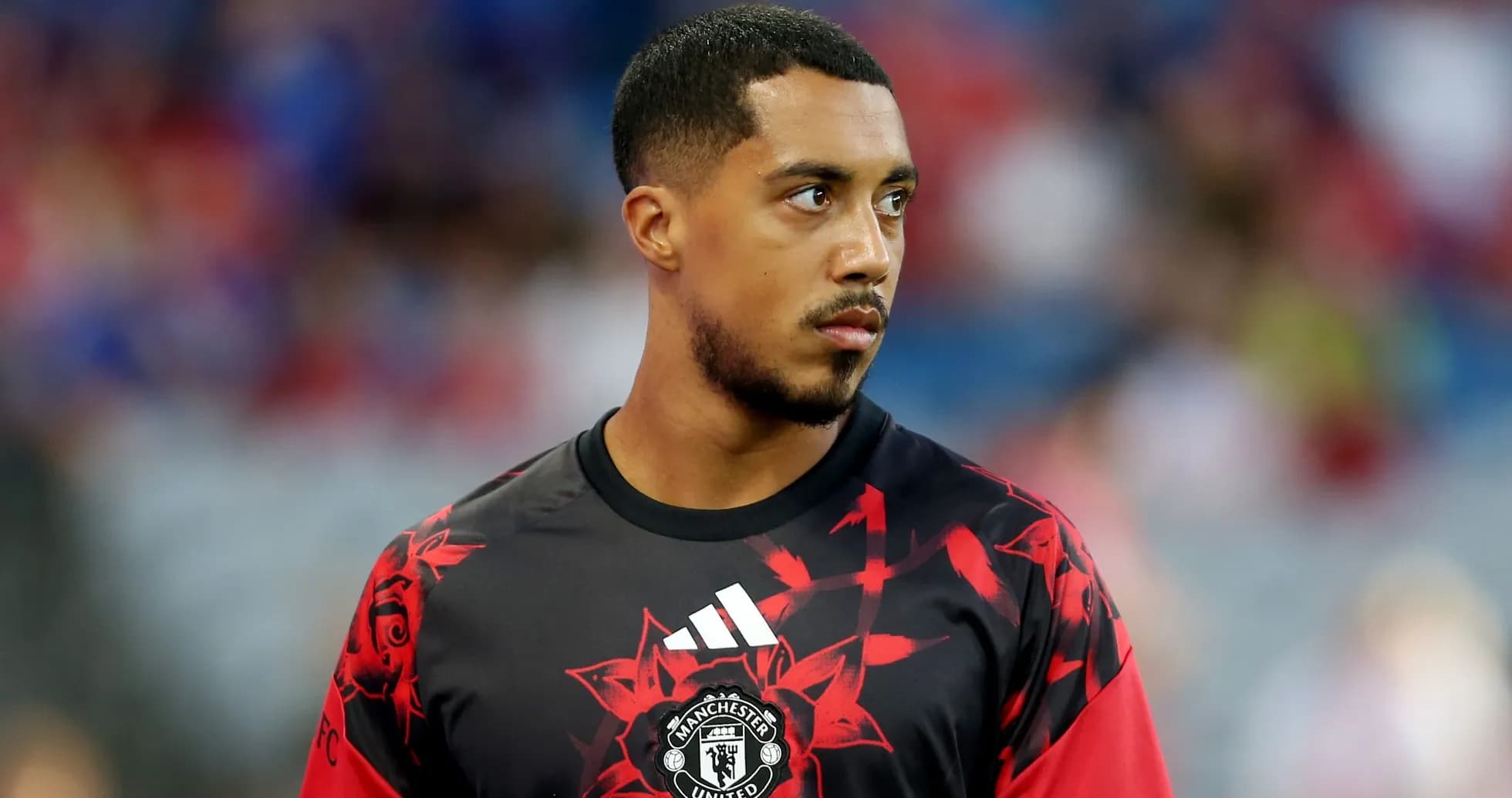 Player in Manchester United warm-up jersey on field