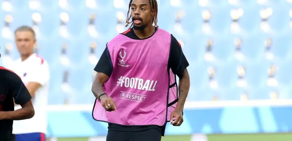 Player in training bib running on pitch