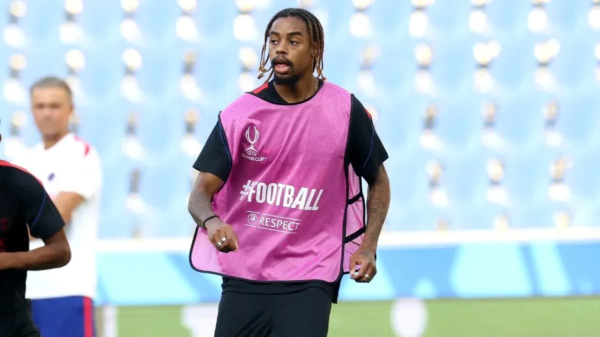 Player in training bib running on pitch