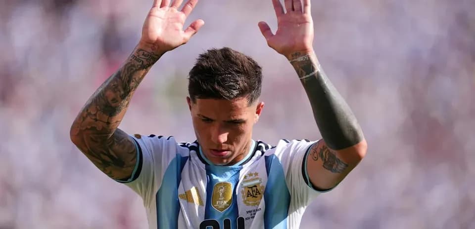 Player raising hands during match in Argentina jersey