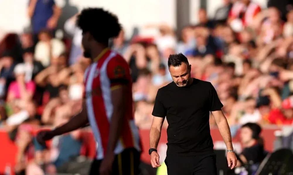 Manager walking past player during a match