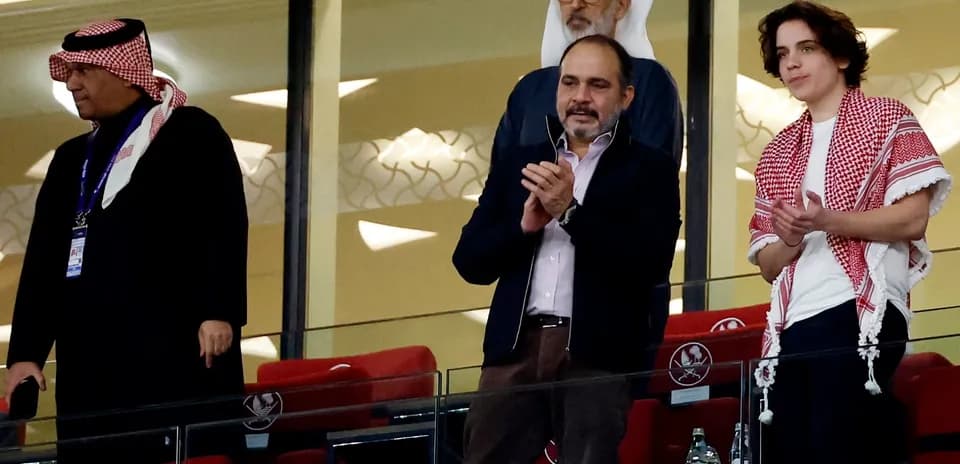 Spectators applauding from VIP box at stadium