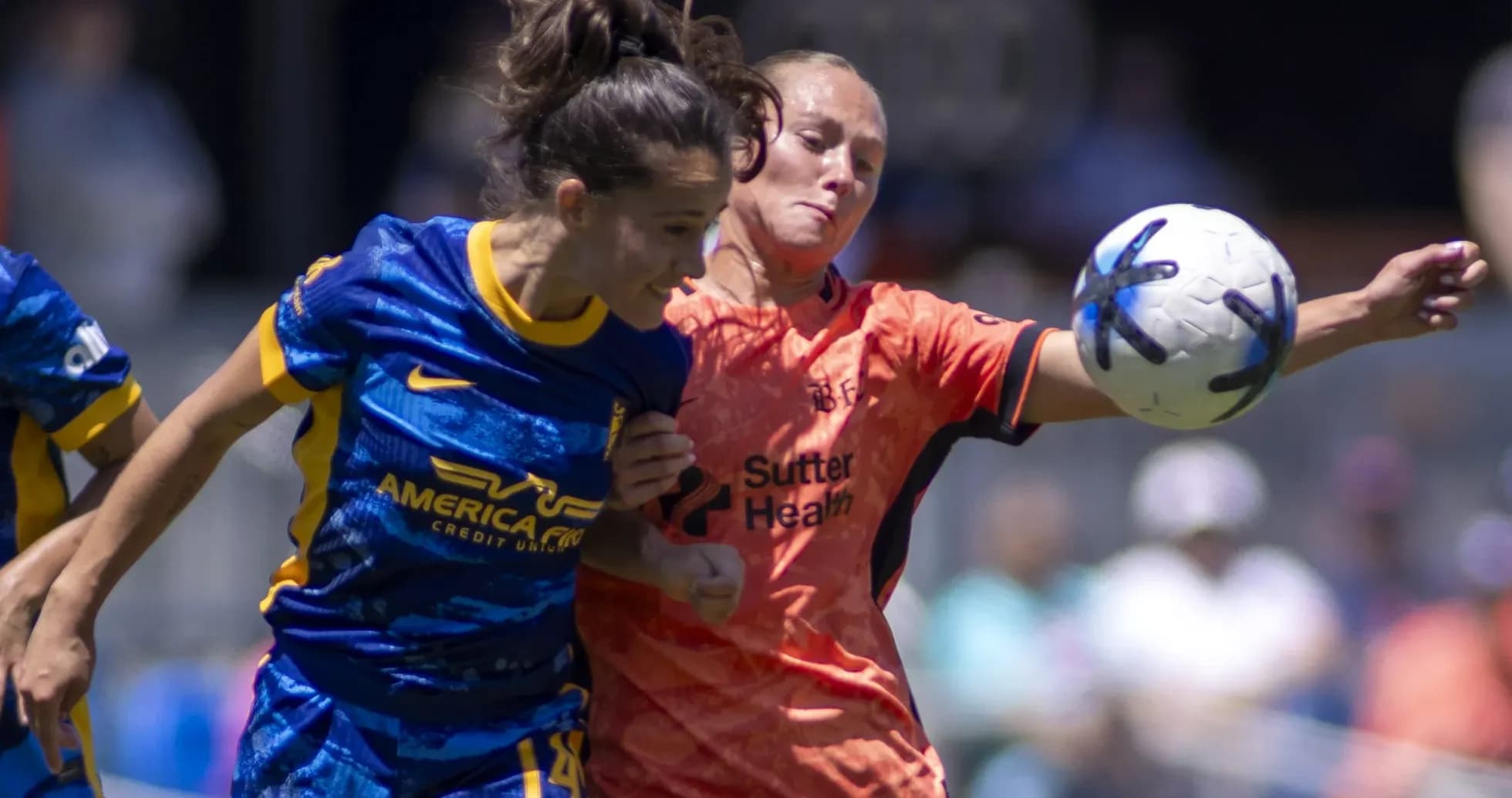 Two players competing for the ball in NWSL match