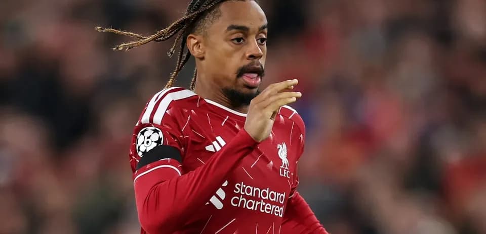 Player running during match wearing Liverpool jersey