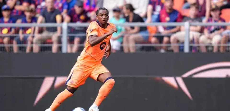 Player in orange kit sprinting during match
