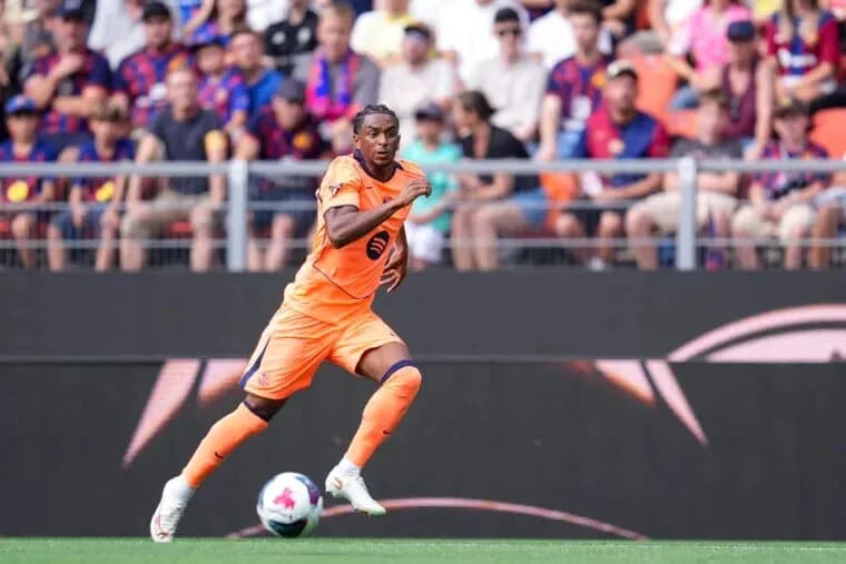 Player in orange kit sprinting during match