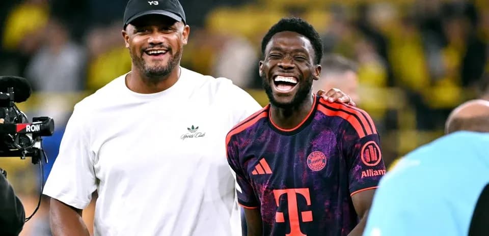 Two men smiling and laughing on the field