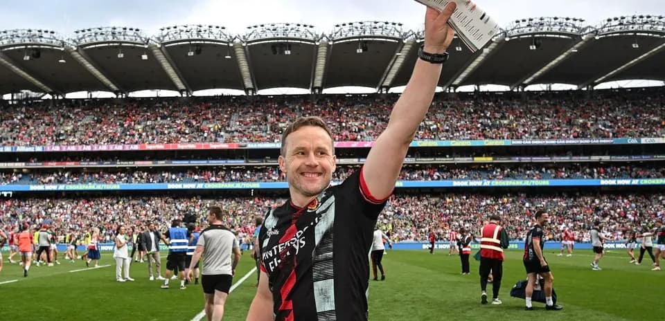Player celebrating on field with fans in background