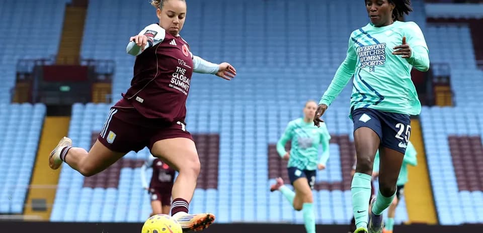 Player kicking the ball during WSL match
