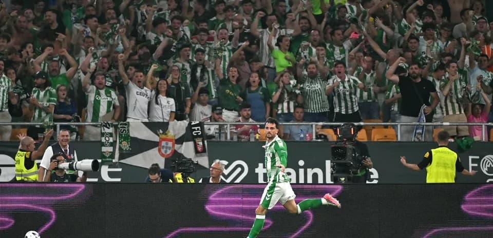 Player celebrating goal with cheering fans in stadium