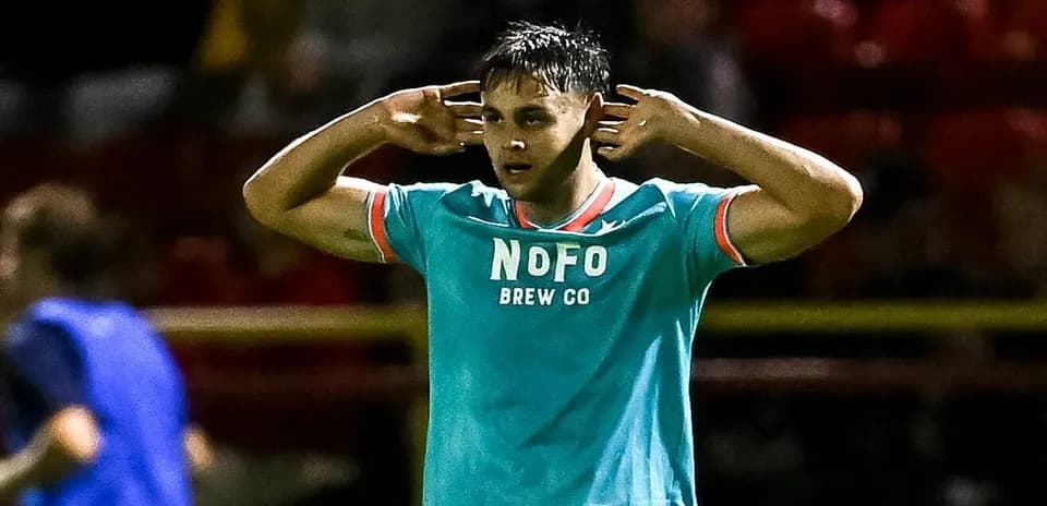 Player celebrating with hands over ears on field