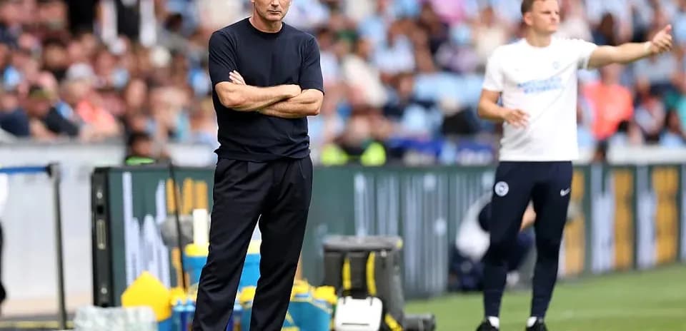 Coaches strategizing during a football match