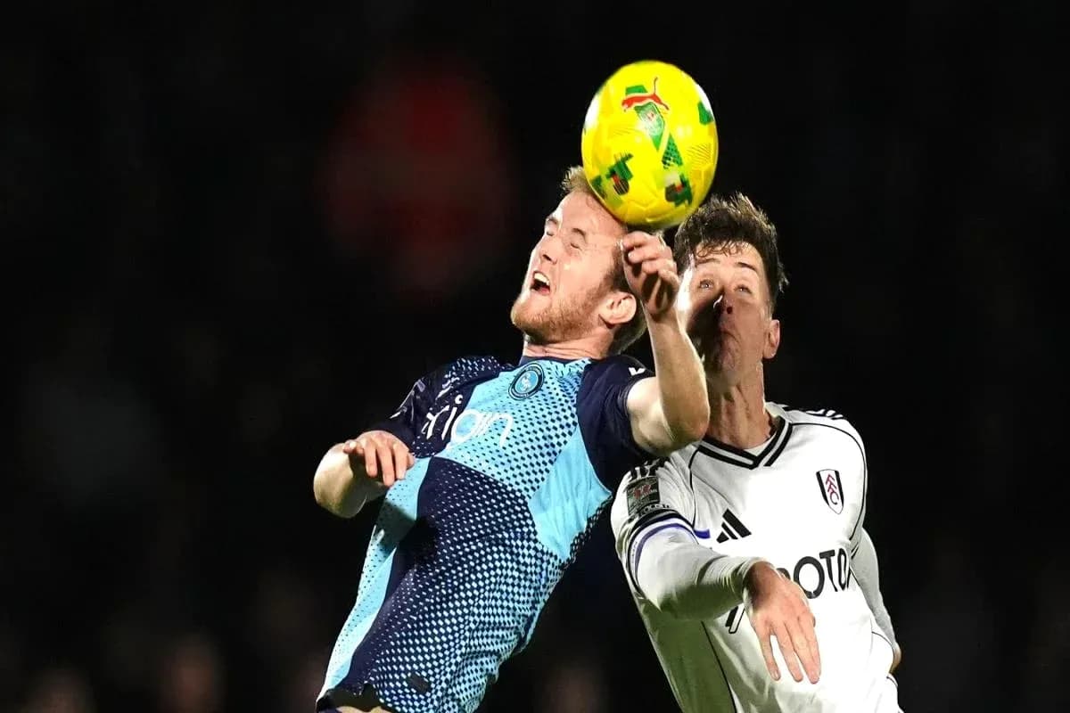 Players challenging for the ball during football match