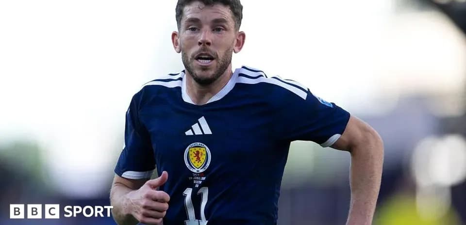 Player running in Scotland national team jersey