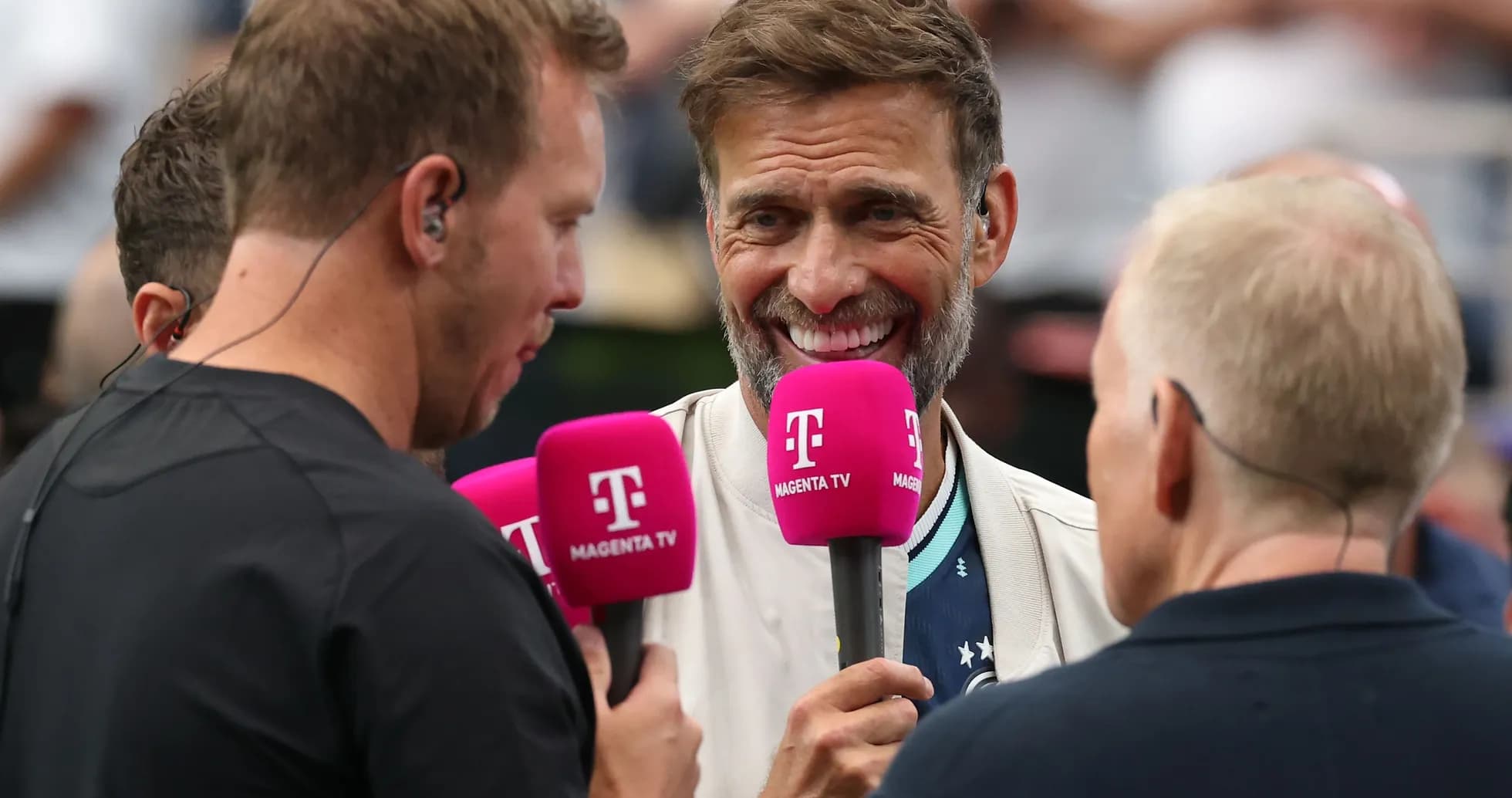 Interviewers holding microphones during a sports event