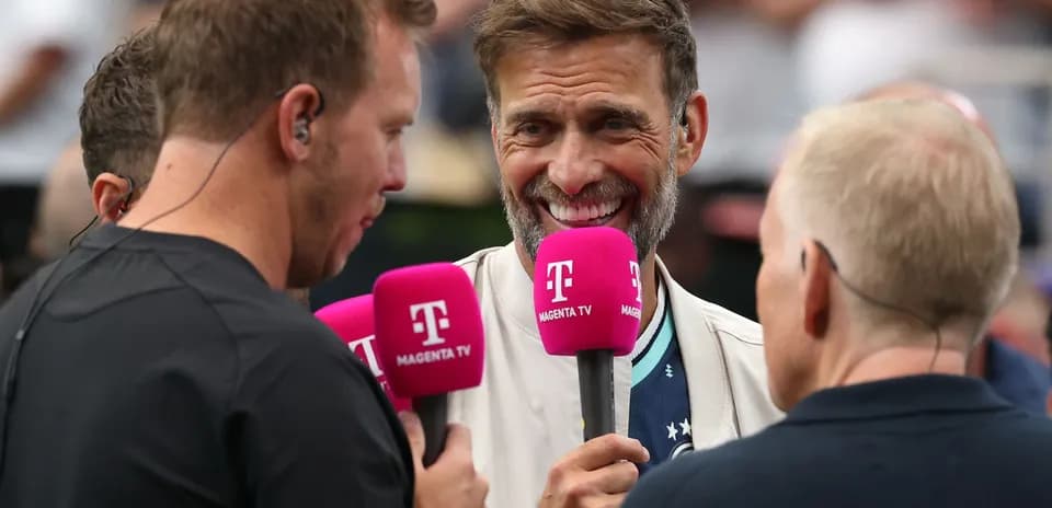 Interviewers holding microphones during a sports event