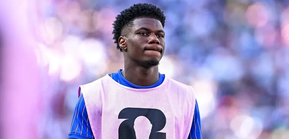 Player wearing pink training bib on sidelines