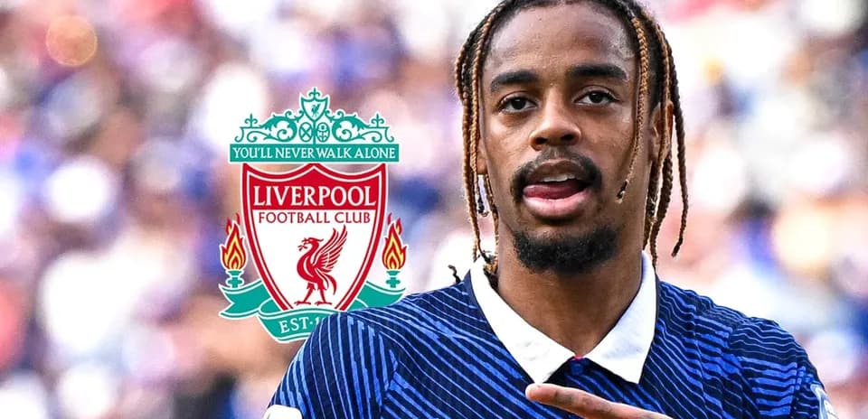 Player gesturing with Liverpool FC logo in background