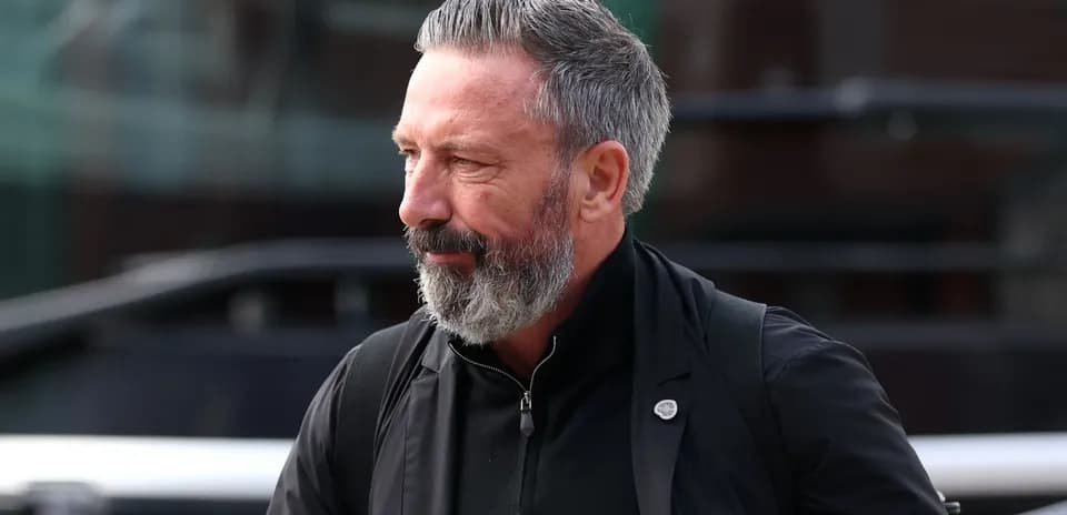 Man with grey beard walking outdoors