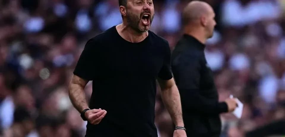 Coach celebrating passionately on the sidelines