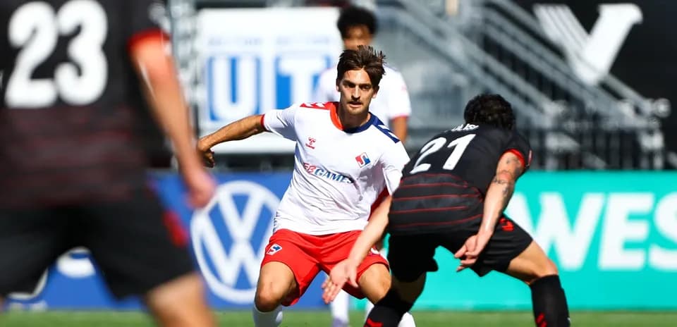 Vancouver FC player dribbling past opponent