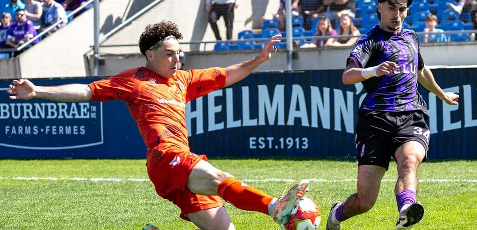 Player sliding to tackle ball during match