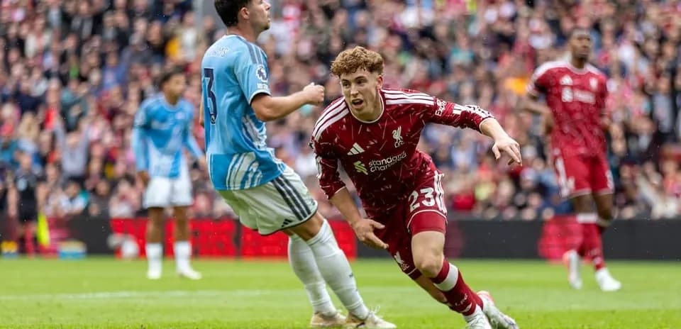 Liverpool player dribbling past Nottingham Forest defender