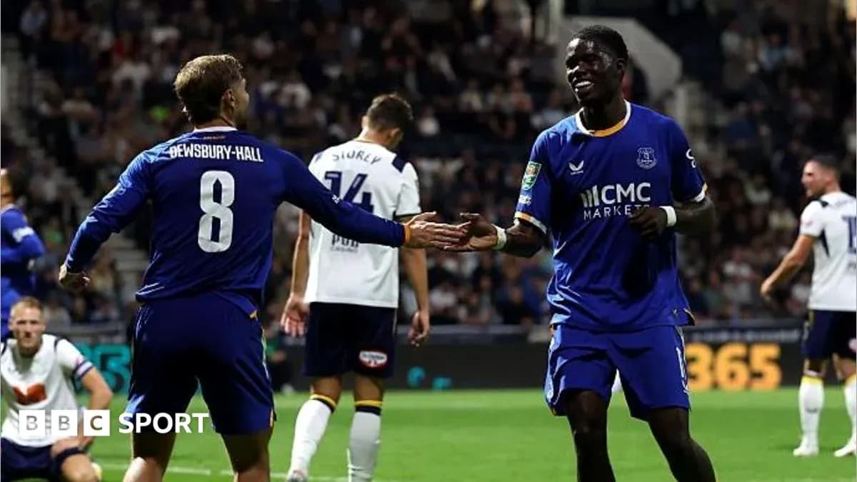 Two players celebrating a goal on the pitch
