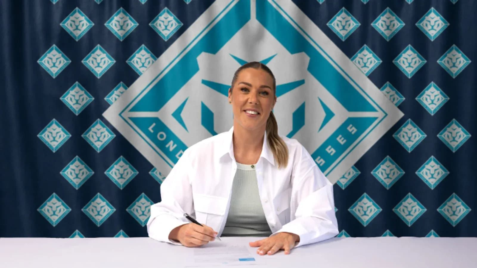 Player signing contract at press conference table