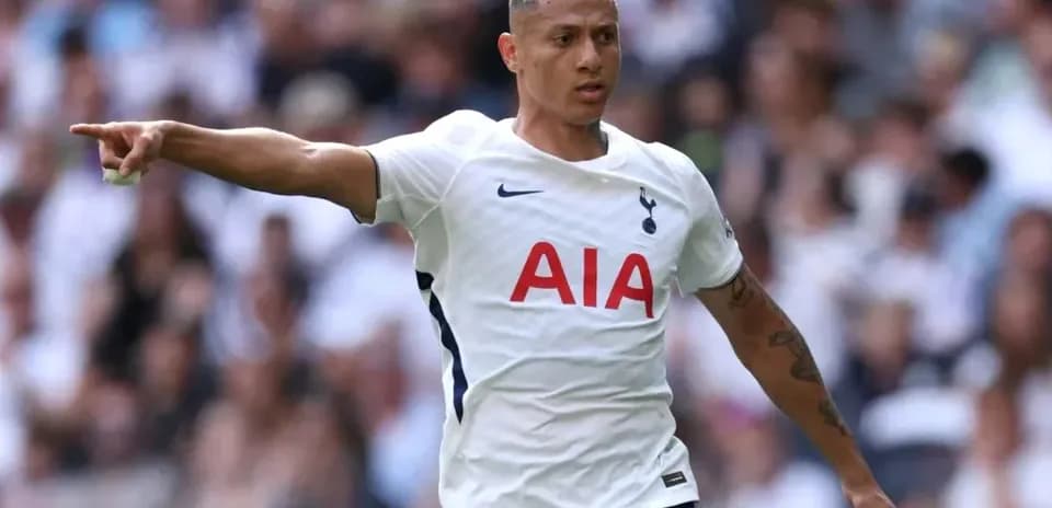 Player pointing during match wearing Tottenham kit