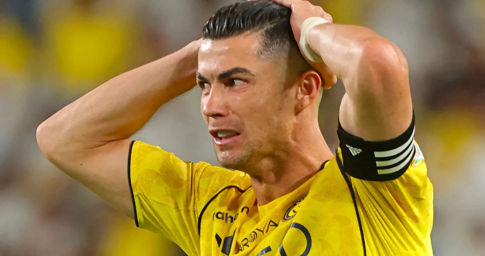 Player in yellow jersey holding head in frustration