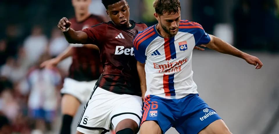 Lyon player challenged by Sparta Praha opponent
