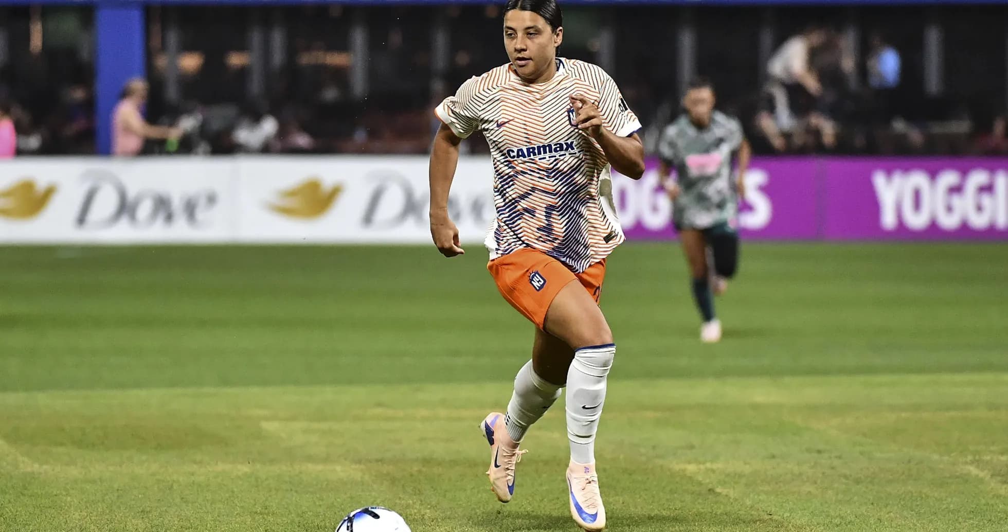 Player running with ball during soccer match