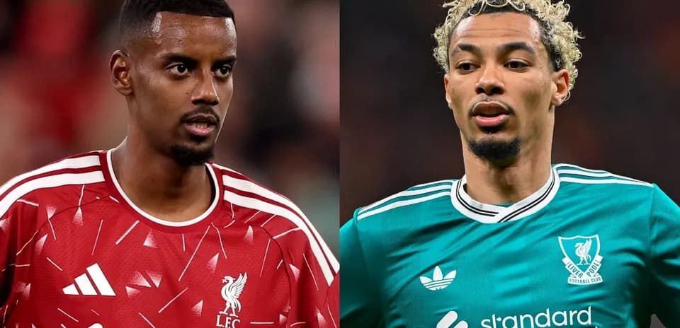 Two Liverpool players in team jerseys during match