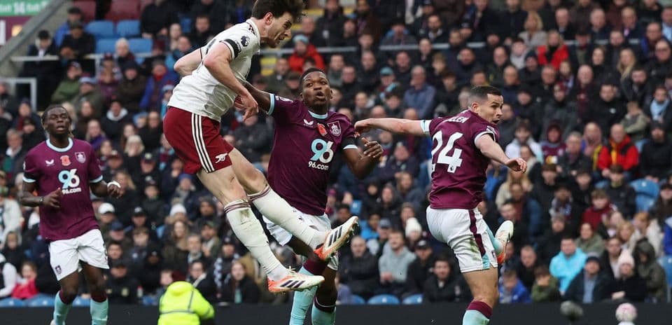 Arsenal player heading ball against Burnley defenders