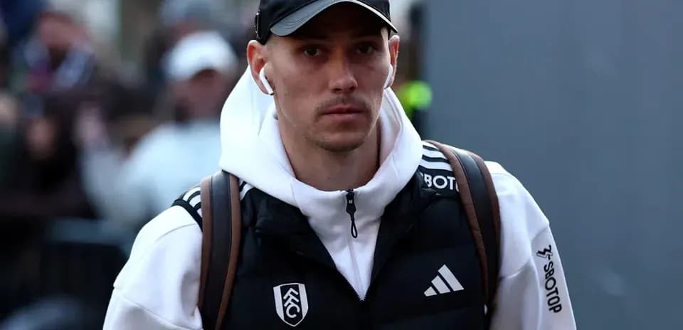 Player walking with earbuds and backpack before match