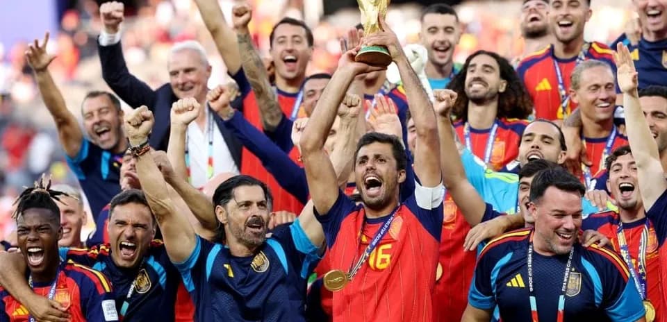 Spain team celebrating victory with World Cup trophy