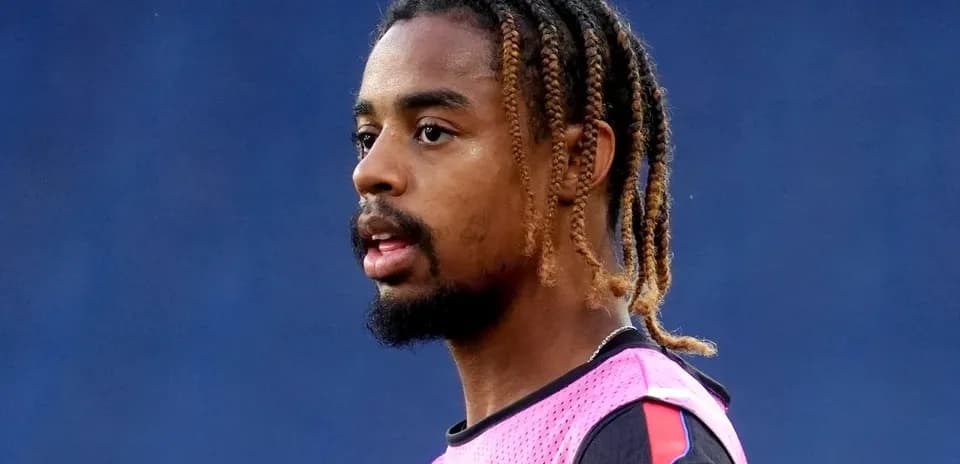 Player wearing a pink training vest on the field
