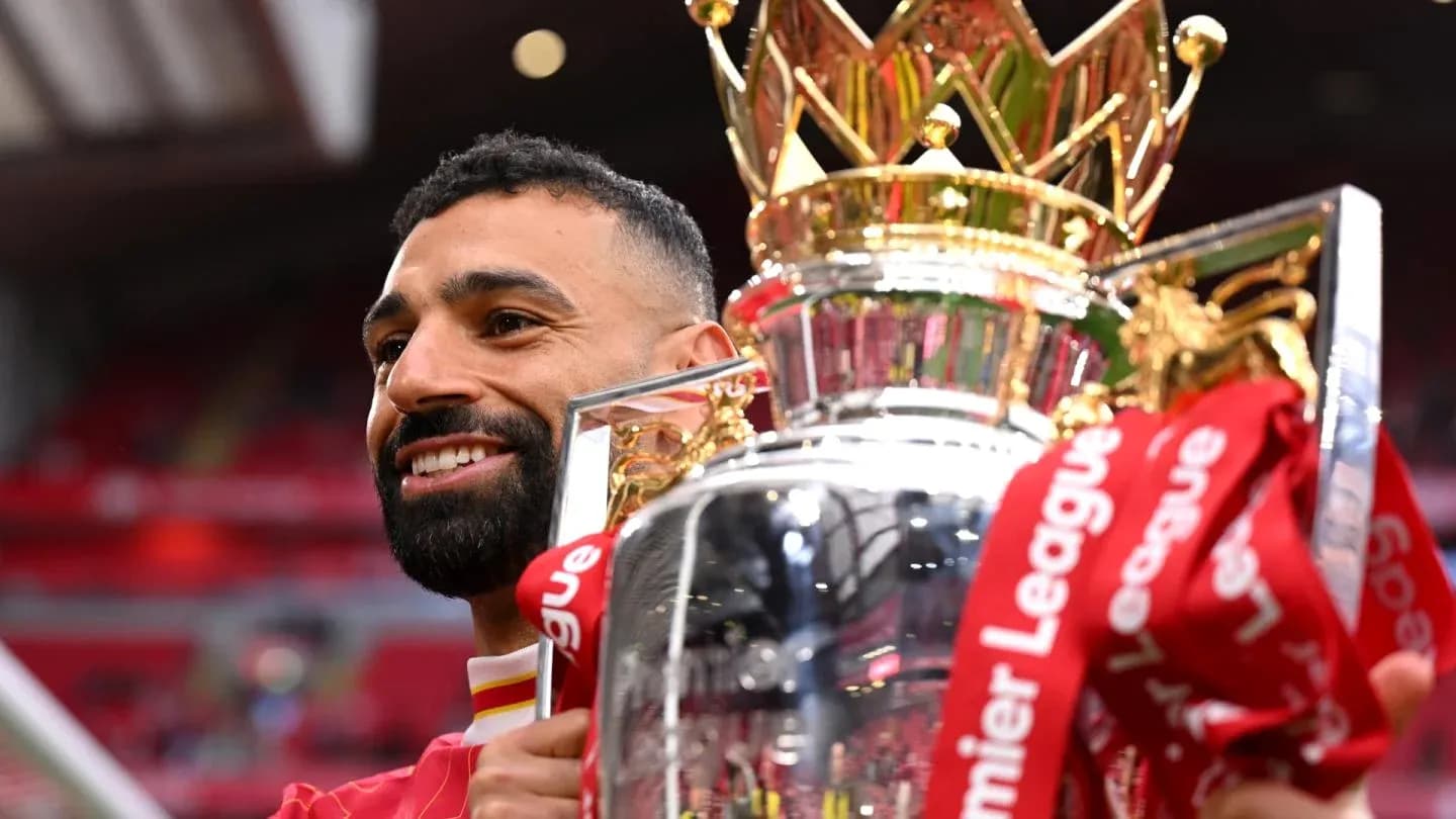 Player celebrating with Premier League trophy